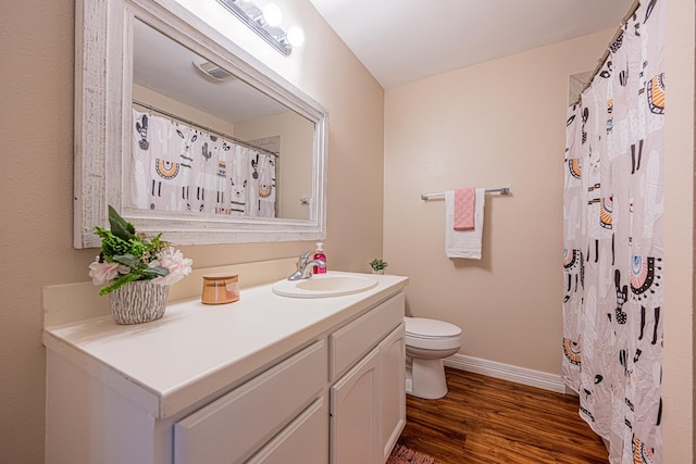 full bathroom with curtained shower, toilet, vanity, wood finished floors, and baseboards