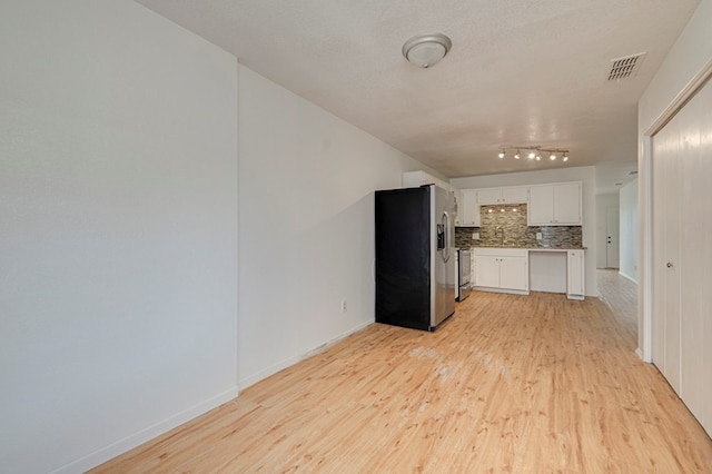 kitchen with visible vents, backsplash, light wood-style floors, white cabinets, and stainless steel fridge with ice dispenser