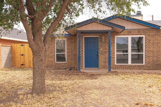 view of front of home with board and batten siding and brick siding