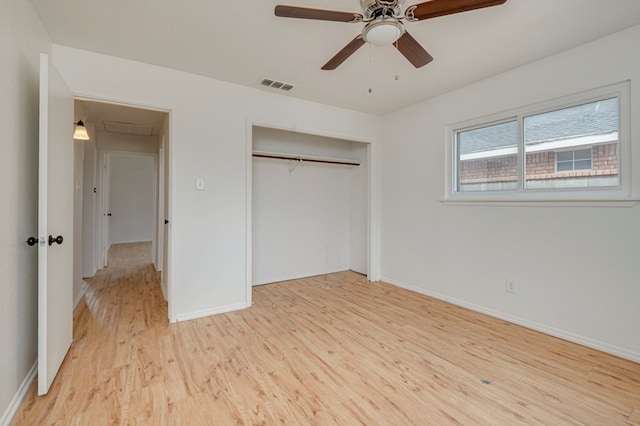 unfurnished bedroom featuring light wood finished floors, baseboards, visible vents, a ceiling fan, and a closet