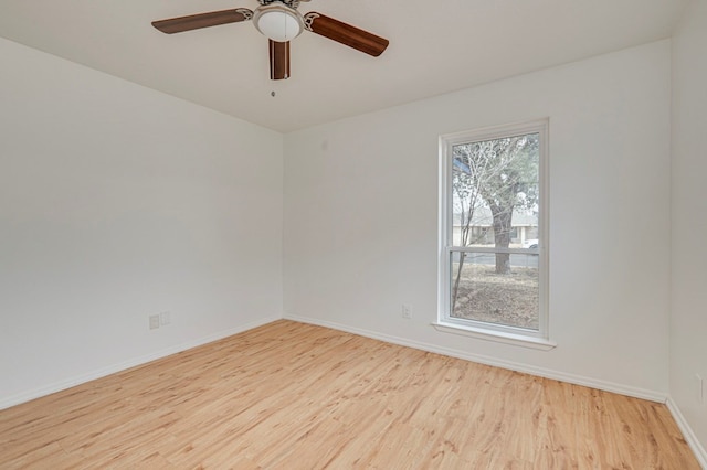 empty room featuring ceiling fan, wood finished floors, and baseboards