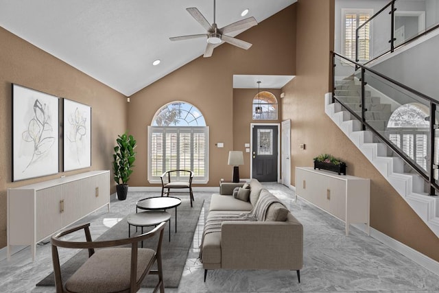 living room featuring ceiling fan and high vaulted ceiling