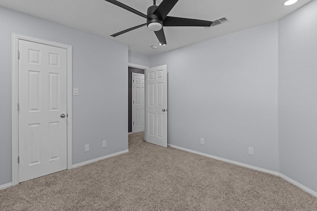 unfurnished bedroom with ceiling fan and light colored carpet