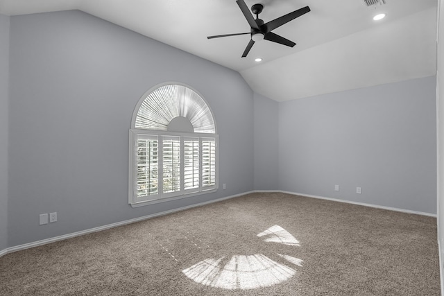 carpeted empty room with ceiling fan and vaulted ceiling