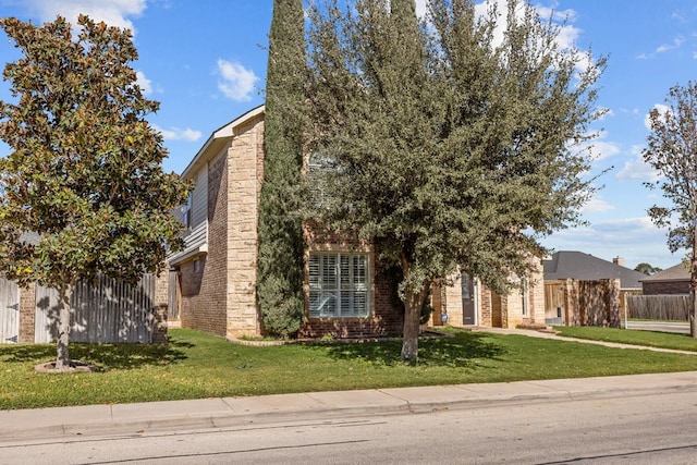 obstructed view of property with a front yard