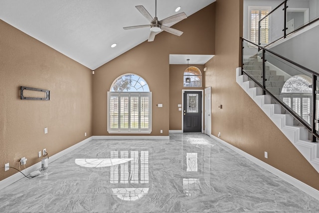 entrance foyer with ceiling fan and high vaulted ceiling