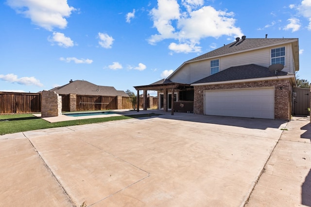 view of front of home featuring a fenced in pool and a patio