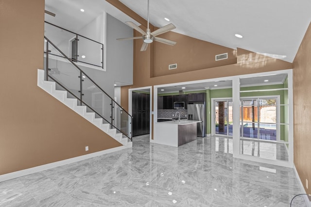 interior space with sink, high vaulted ceiling, and ceiling fan