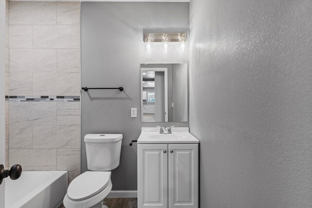 1344 E 5th St, Odessa, TX 79761 - bathroom featuring toilet, vanity, and bathing tub / shower combination