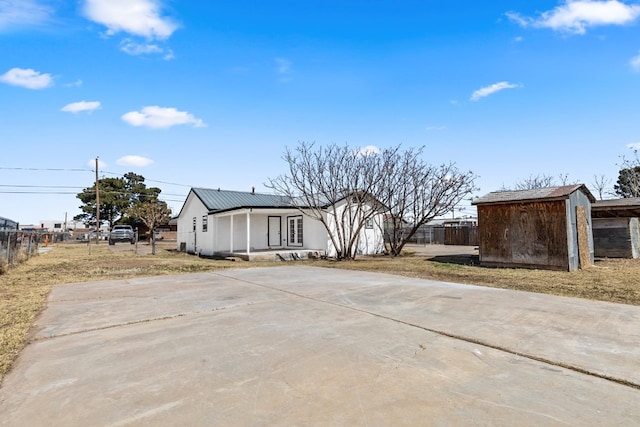 1344 E 5th St, Odessa, TX 79761 - view of front facade with metal roof, stucco siding, and driveway