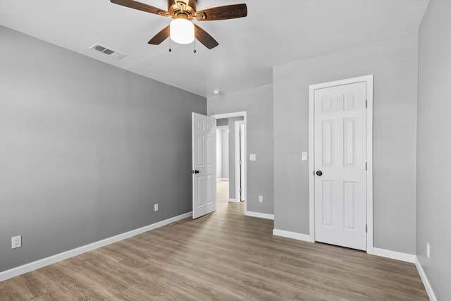 1344 E 5th St, Odessa, TX 79761 - unfurnished bedroom featuring wood finished floors, baseboards, and a ceiling fan