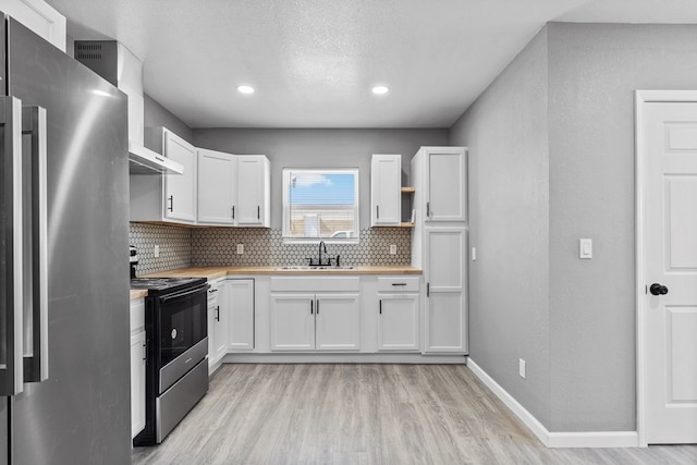 1344 E 5th St, Odessa, TX 79761 - kitchen featuring appliances with stainless steel finishes, wooden counters, a sink, decorative backsplash, and recessed lighting