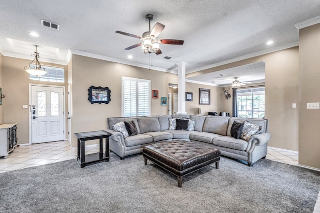 living room with ceiling fan, crown molding, light colored carpet, light tile patterned flooring, and a textured ceiling