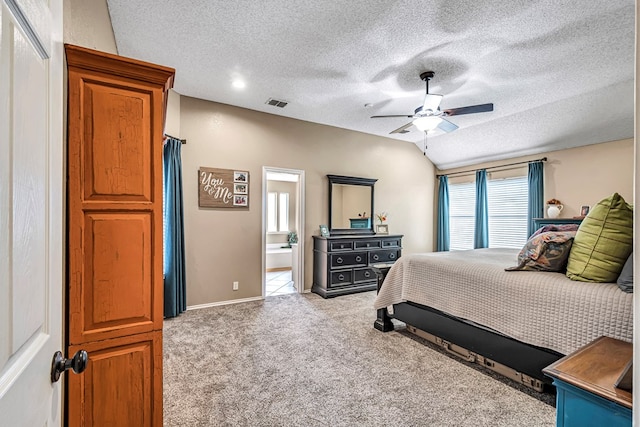 carpeted bedroom featuring a textured ceiling, ensuite bathroom, ceiling fan, and baseboards