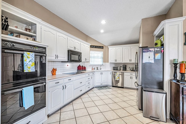 kitchen with black appliances, white cabinets, a textured ceiling, backsplash, and light countertops