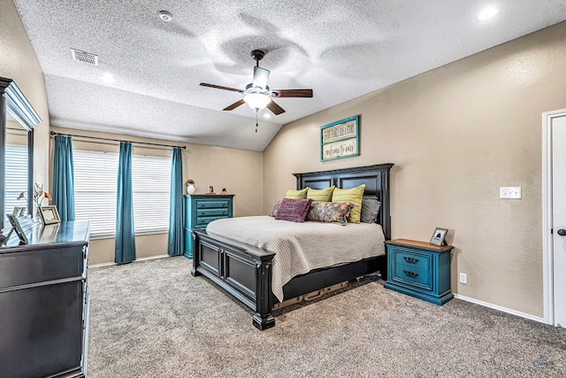 bedroom with carpet, baseboards, a textured ceiling, lofted ceiling, and ceiling fan