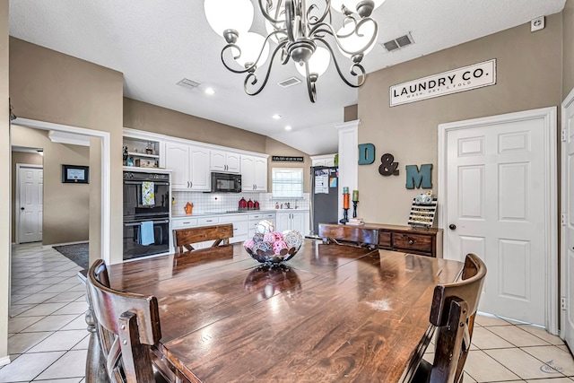 dining room featuring light tile patterned flooring, a chandelier, vaulted ceiling, and recessed lighting