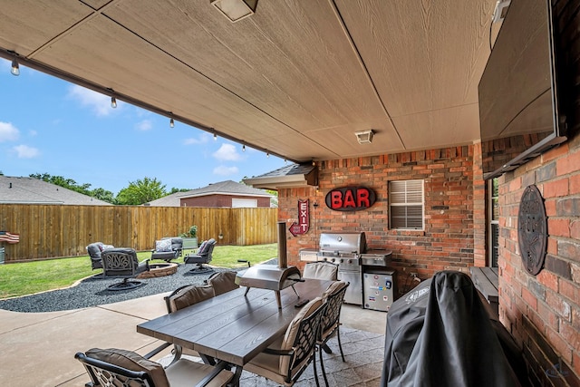 view of patio / terrace with a fenced backyard, a grill, and outdoor dining area