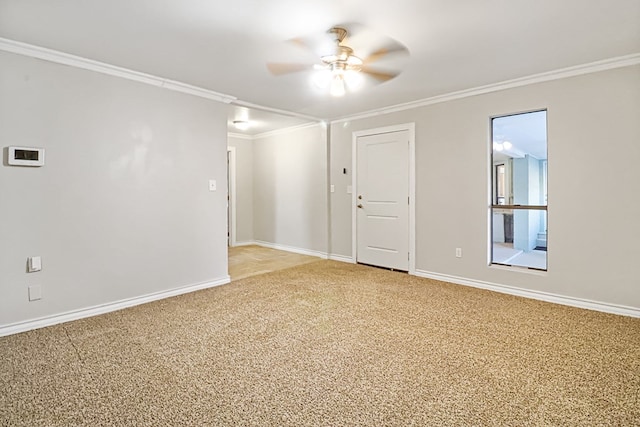 carpeted spare room with ceiling fan and crown molding