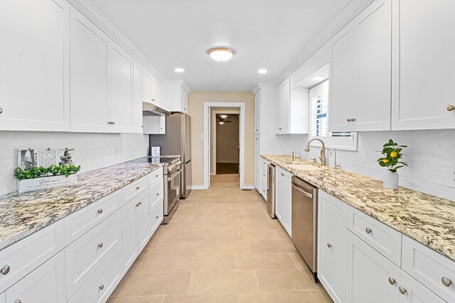 kitchen featuring decorative backsplash, stainless steel appliances, and white cabinetry