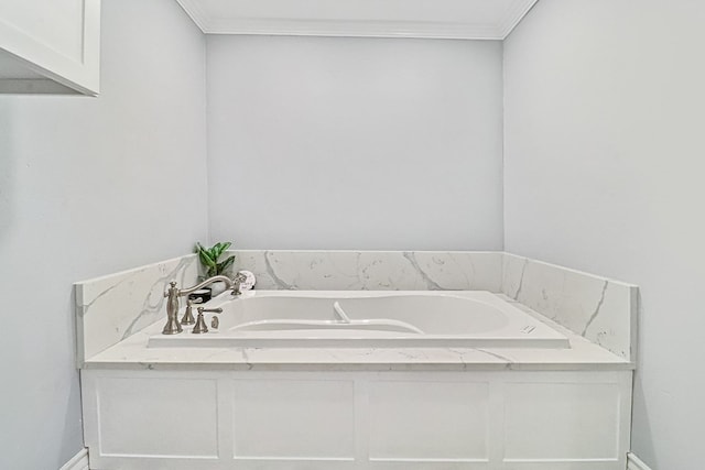 bathroom featuring a bathing tub and ornamental molding