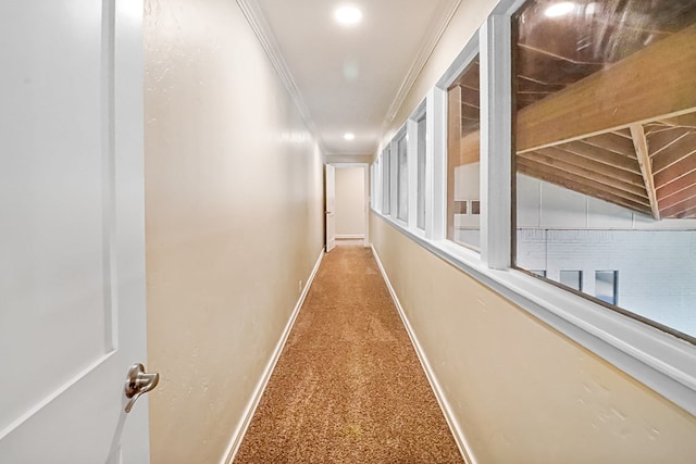 corridor with crown molding, carpet floors, and vaulted ceiling