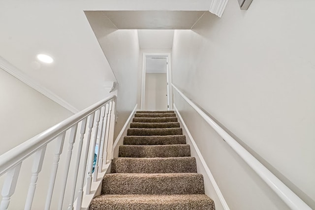 staircase featuring crown molding