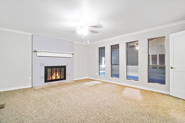 unfurnished living room featuring ceiling fan, crown molding, carpet, and a brick fireplace