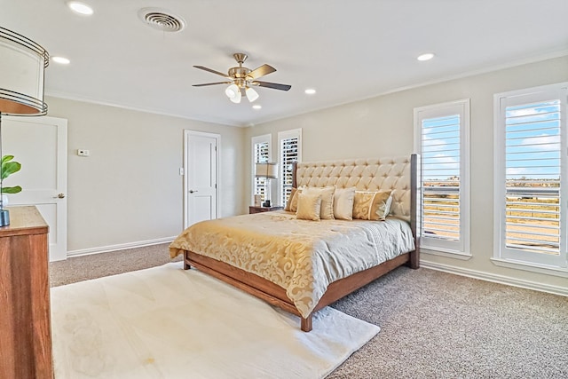 carpeted bedroom with ceiling fan and ornamental molding