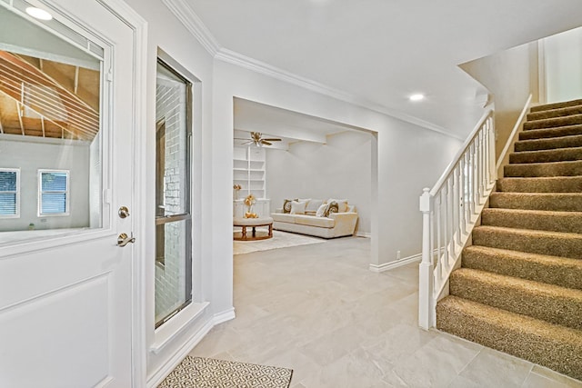 entryway featuring ceiling fan and crown molding