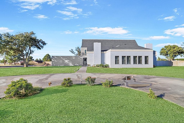 back of house featuring a lawn