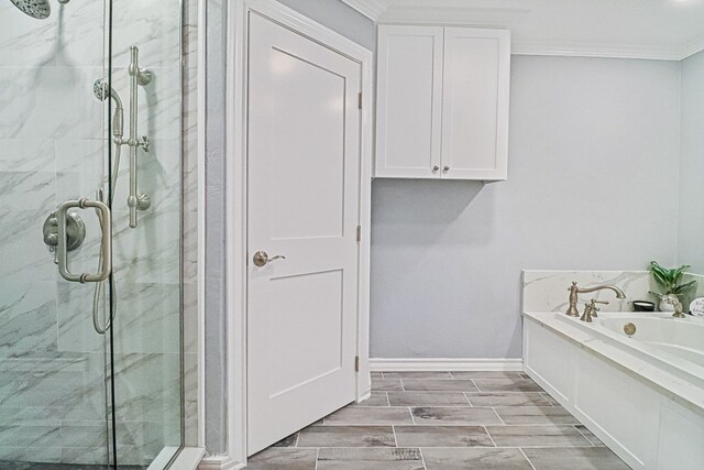 bathroom featuring shower with separate bathtub and ornamental molding