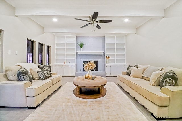 living room with ceiling fan and beam ceiling