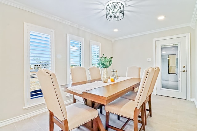 dining space featuring a chandelier, crown molding, and light tile patterned flooring