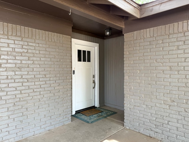 entrance to property with brick siding