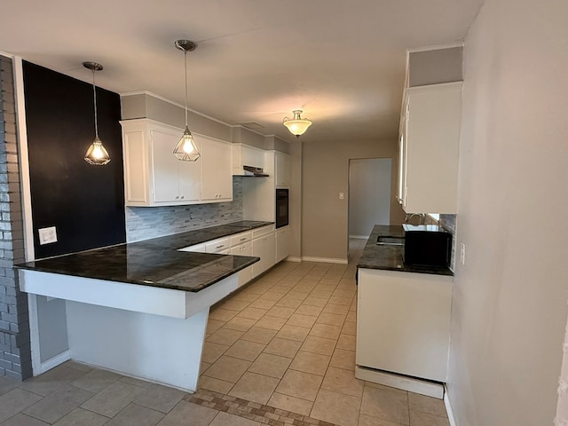 kitchen featuring dark countertops, backsplash, black appliances, light tile patterned floors, and white cabinets