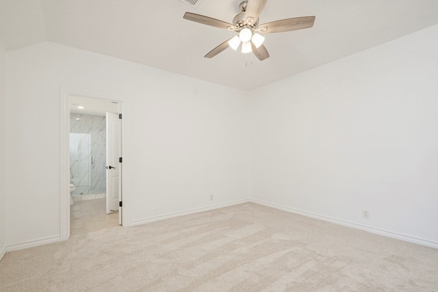 unfurnished room featuring lofted ceiling, light carpet, ceiling fan, and baseboards