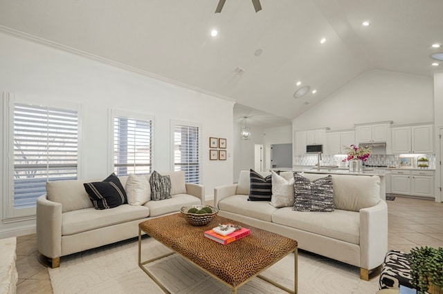 living area with high vaulted ceiling, light tile patterned flooring, a ceiling fan, and recessed lighting