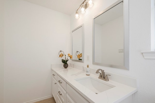 bathroom featuring baseboards and vanity