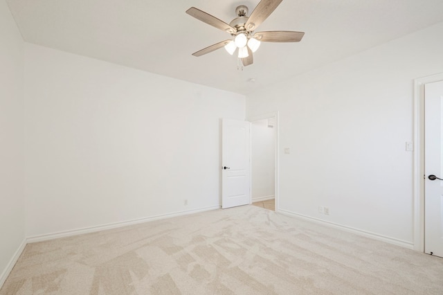 unfurnished room with light colored carpet, ceiling fan, and baseboards