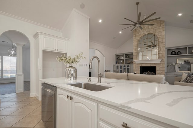 kitchen featuring stainless steel dishwasher, a ceiling fan, open floor plan, white cabinets, and a sink