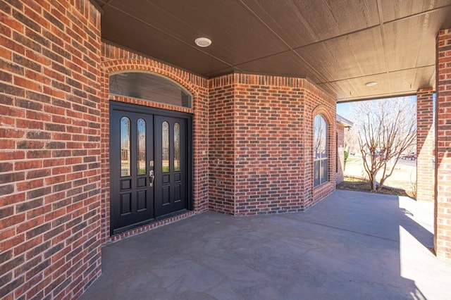 doorway to property featuring brick siding