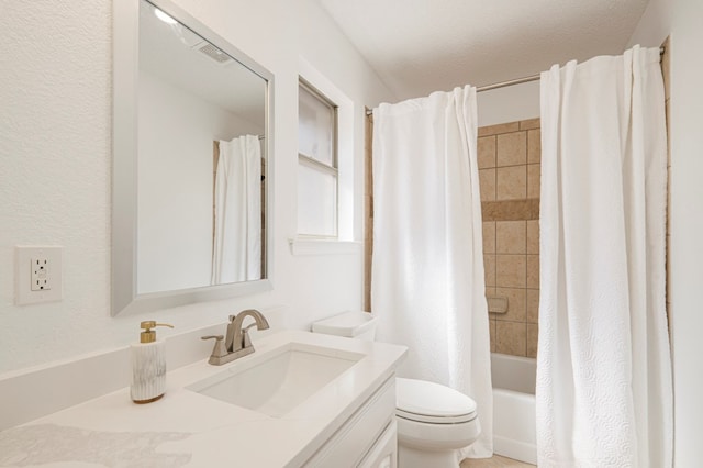 full bathroom with a textured ceiling, vanity, toilet, and shower / bath combo with shower curtain