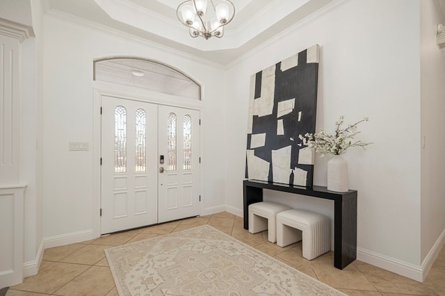 entrance foyer with baseboards, crown molding, a chandelier, and a tray ceiling