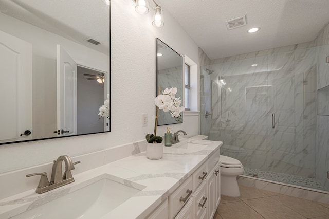 full bath with toilet, a marble finish shower, visible vents, and a sink