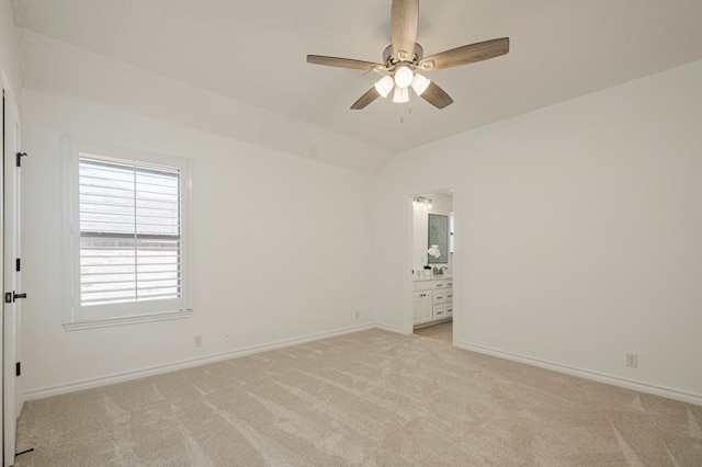 unfurnished room with lofted ceiling, light carpet, ceiling fan, and baseboards