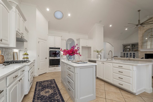 kitchen featuring light countertops, appliances with stainless steel finishes, white cabinets, and a center island