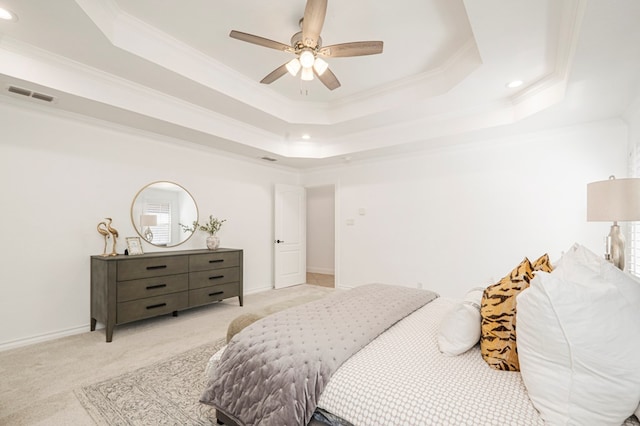 bedroom featuring visible vents, a raised ceiling, crown molding, and light colored carpet