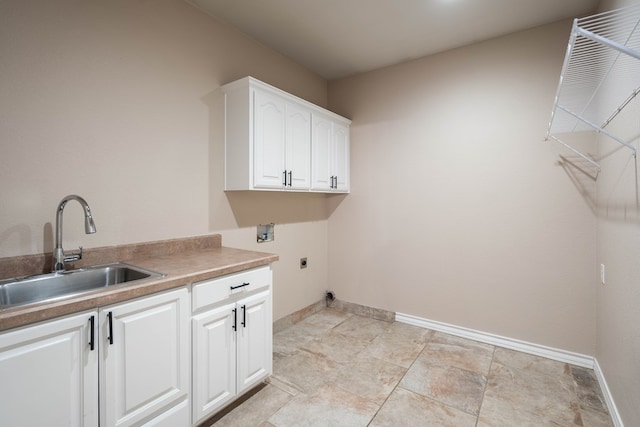 clothes washing area with washer hookup, cabinets, hookup for an electric dryer, and sink