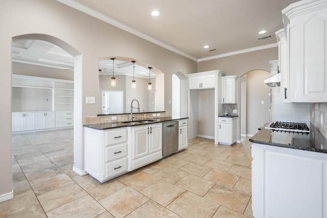 kitchen featuring sink, decorative light fixtures, white cabinetry, dark stone countertops, and ornamental molding